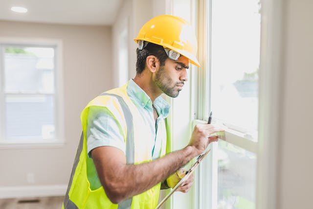 a-person-inspecting-a-window